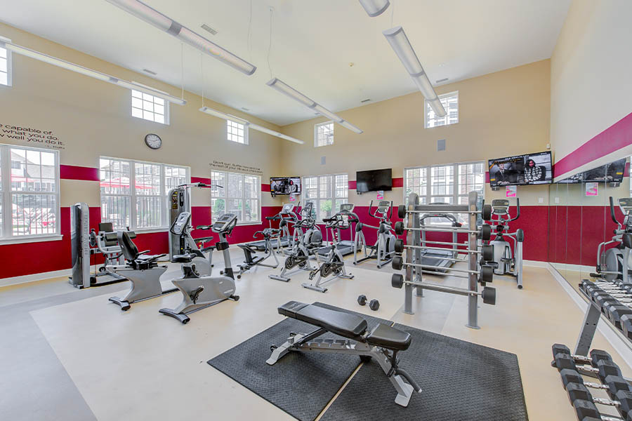 White and dark red fitness gym located at Hamilton Luxury Apartments.