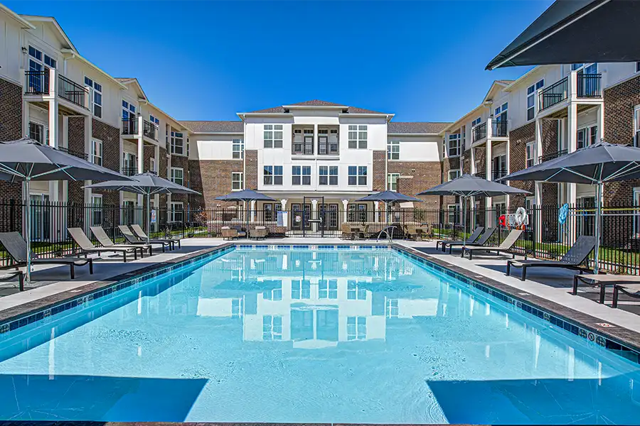 Pristine pool surrounded by apartment buildings at SOMO Apartments.